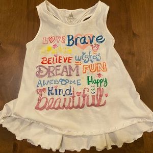 White Disney tank top with rainbow lettering and styling detail. Ruffled hem